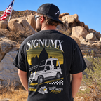 Man wearing washed black Vatican City Racing Catholic shirt, back racing graphic. Model is 5'10" and wearing a Large